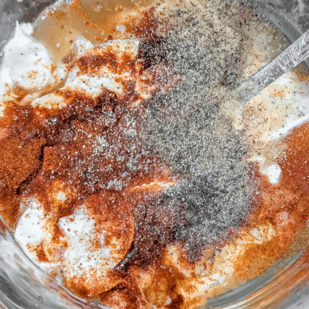 Creamy chipotle southwest chicken salad with spices and toppings.