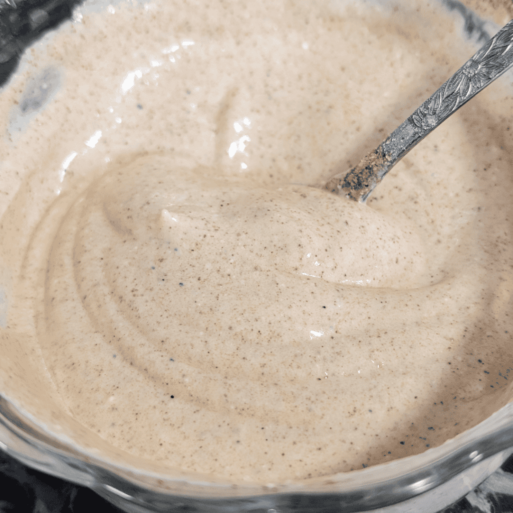 Creamy chipotle southwest dressing in a glass bowl with a spoon.