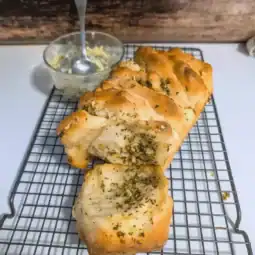 easy pizza dough garlic bread pull apart loaf on wire rack