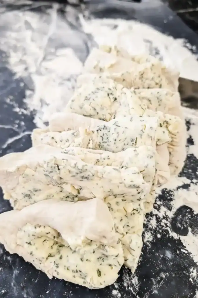 stand pizza dough garlic bread layers together on work surface