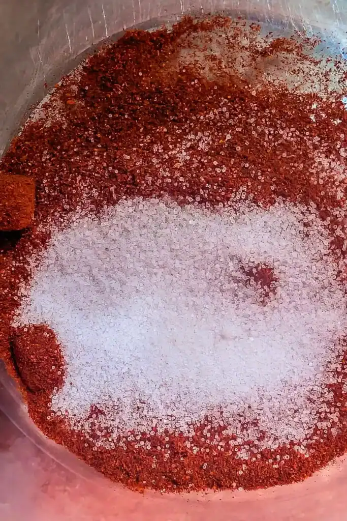 adding salt to smoked paprika for spice blend