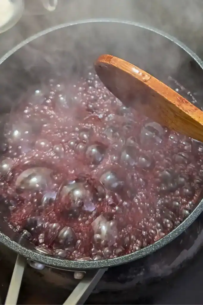 cooking cherries and sugar in pot