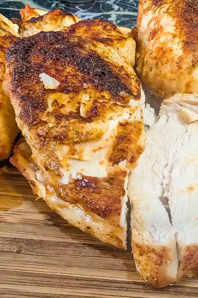 spiced air fryer chicken breast on cutting board