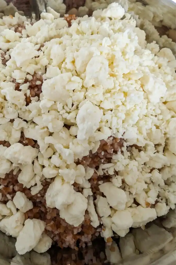 adding crumbled feta cheese to salad