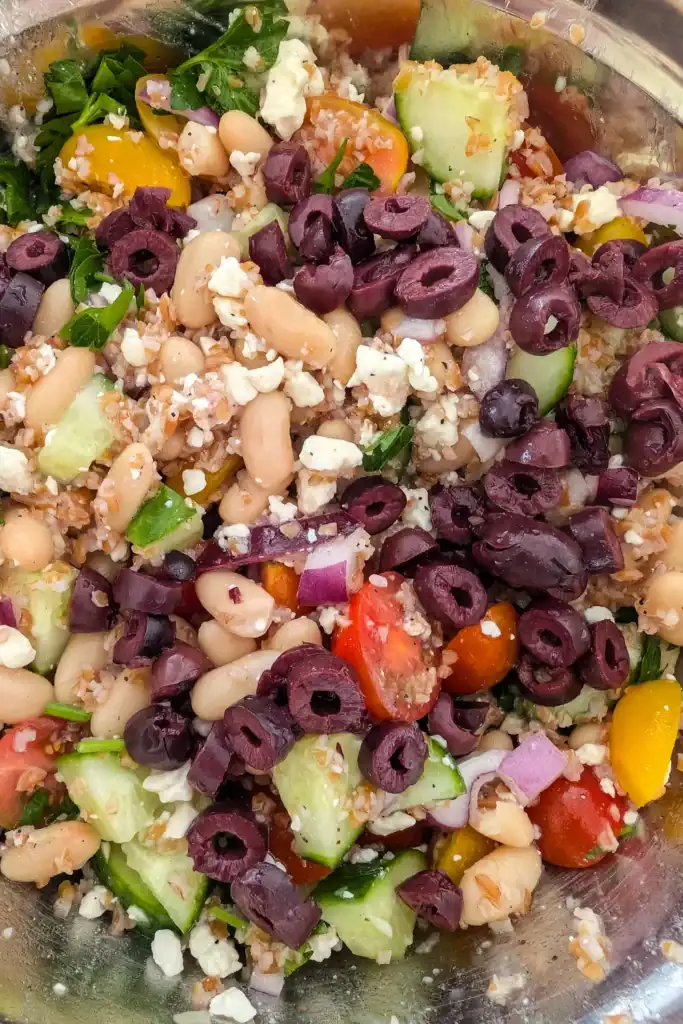 adding olive to salad