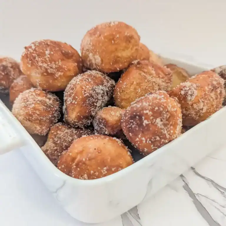 white marble dish with a stack of chai sugared donut holes