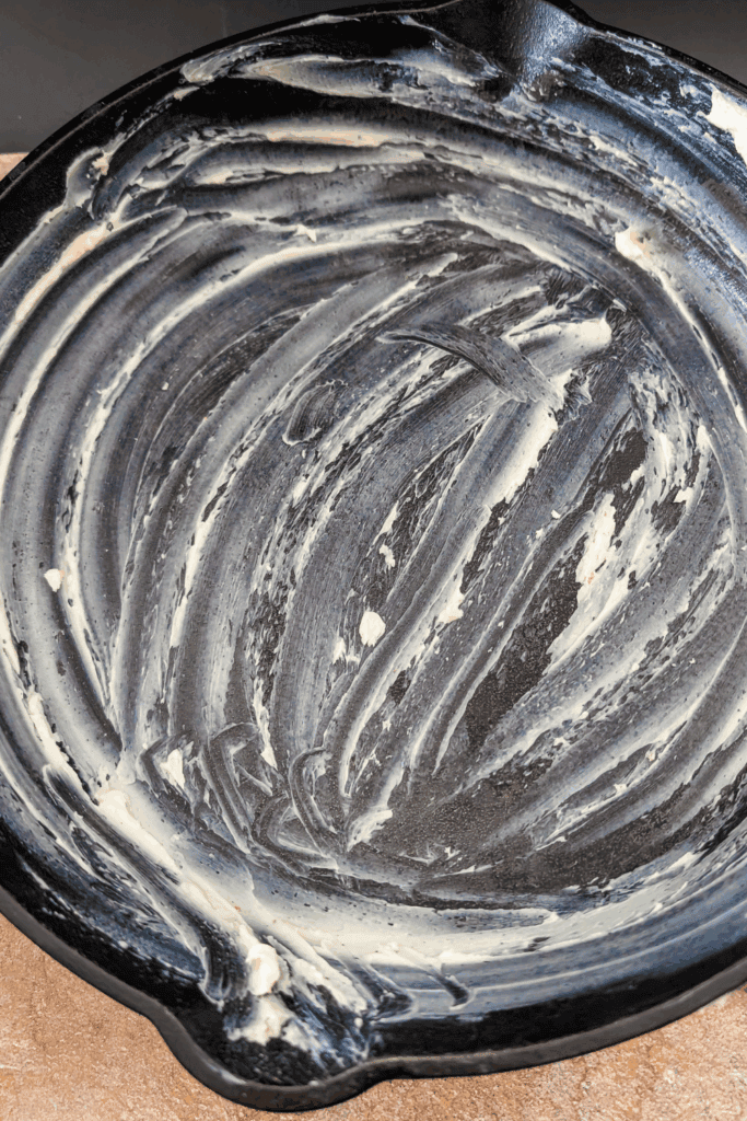 grease with butter the cast iron skillet