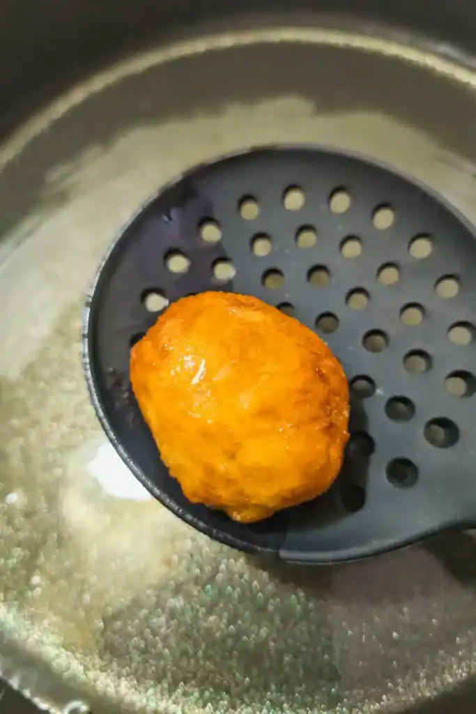 lift fried dough ball from hot oil
