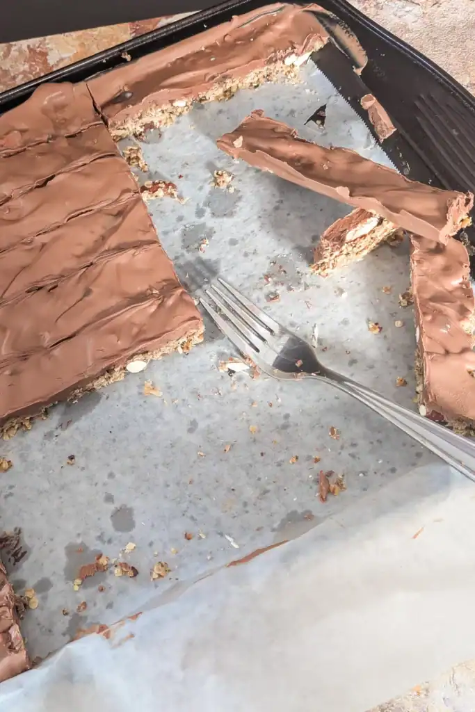 using fork to lift granola from jelly roll pan
