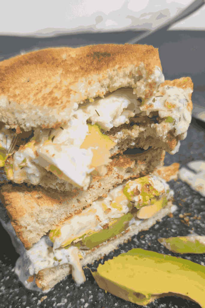 a bite out of one half the green goddess breakfast sandwich