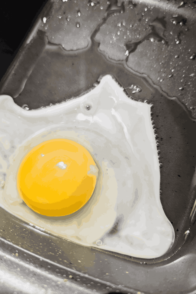 cracking the egg into the hot oil