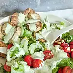 grilled potato corn summer salad with serving utensil on right of bowl