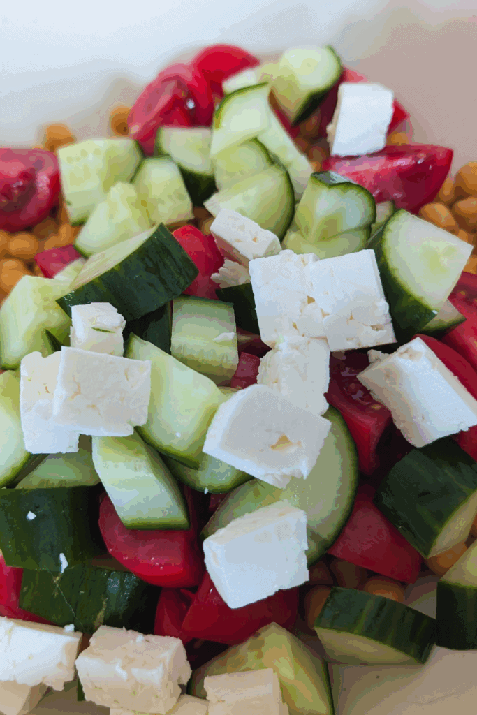 adding veggies and cheese to chickpeas