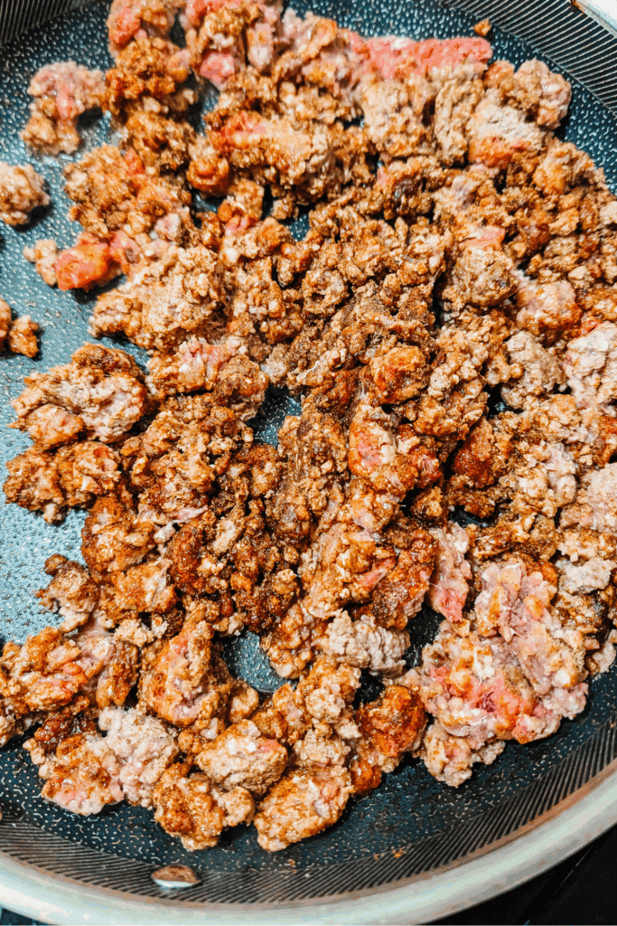 breaking ground beef down with chili spices