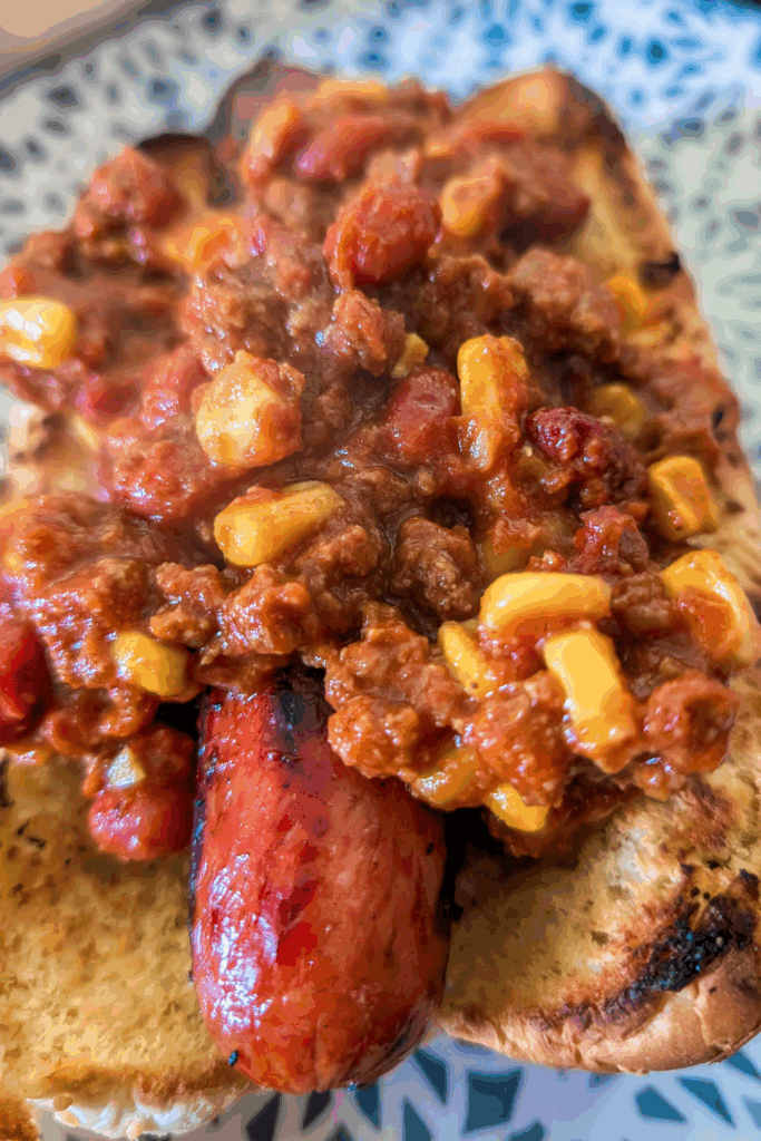 covering the hot dog with chili