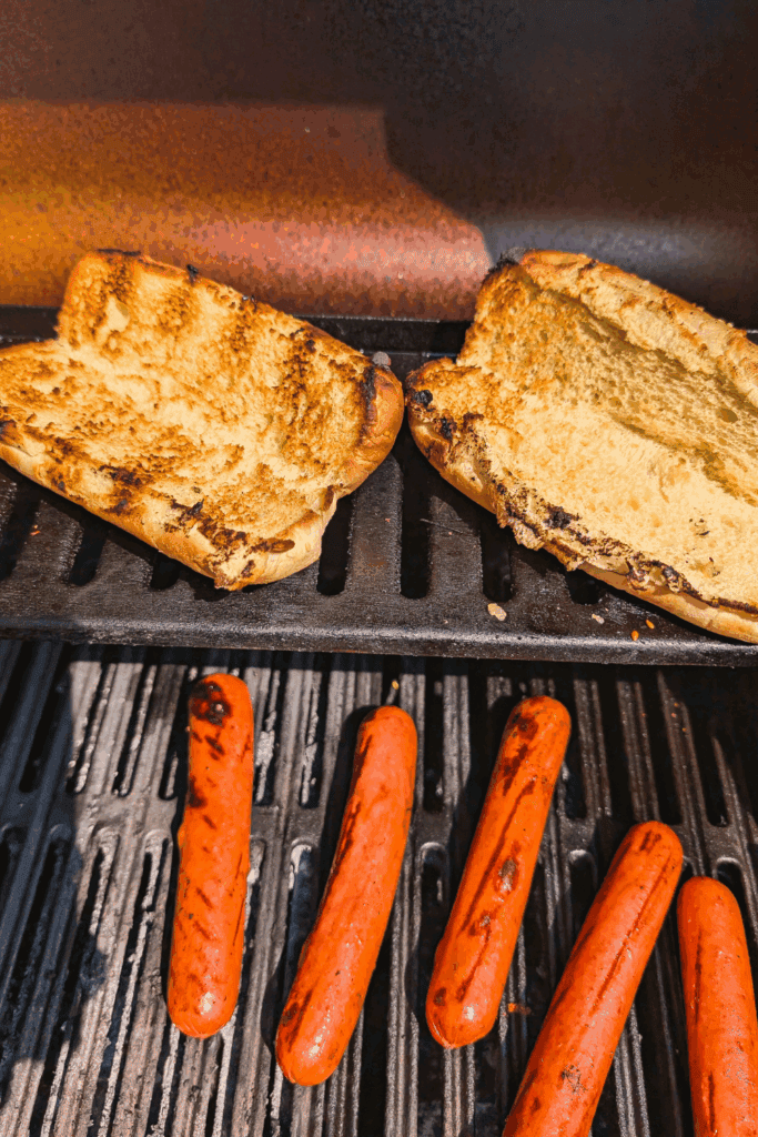 toasting hot dog buns and hot dogs on BBQ