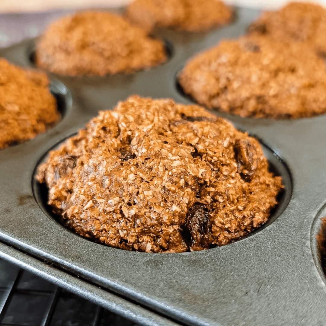 A muffin pan filled with chocolate chip muffins.