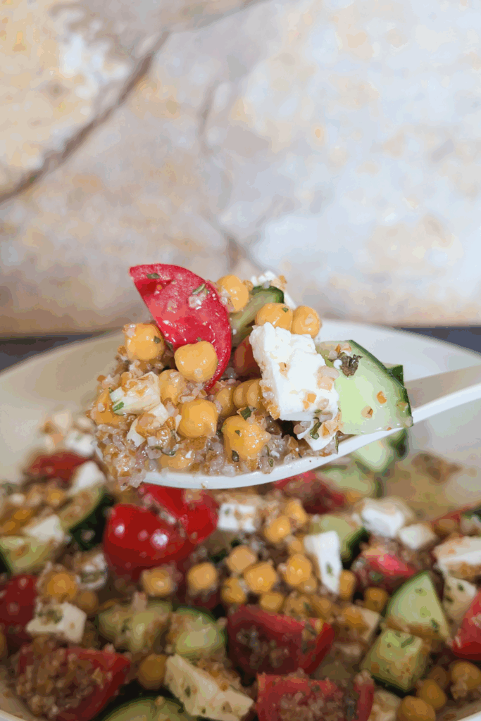 scooping up a spoonful of chickpea salad