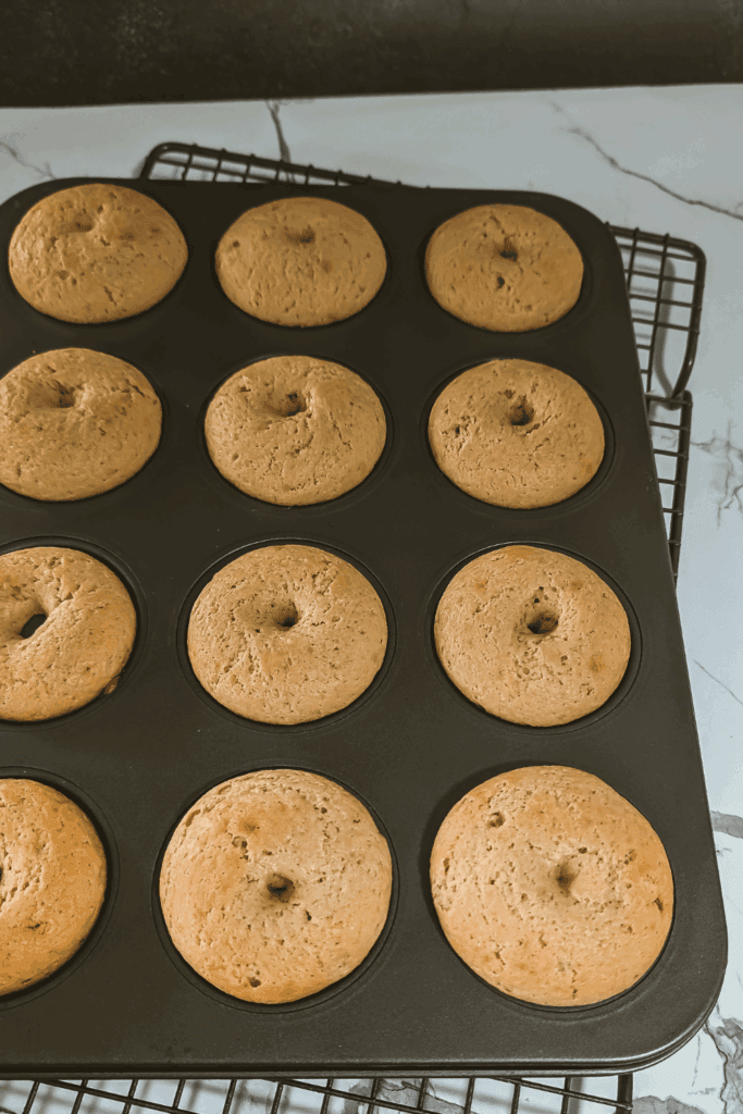 baked golden maple donuts cooling in pan