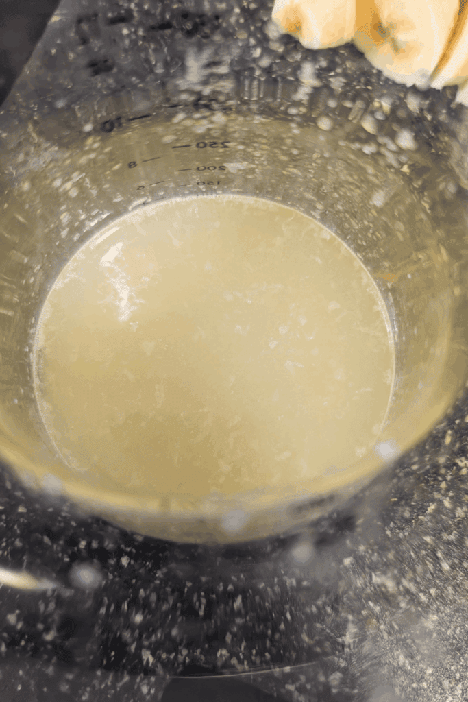 Liquid batter in a measuring cup for cooking or baking recipes.