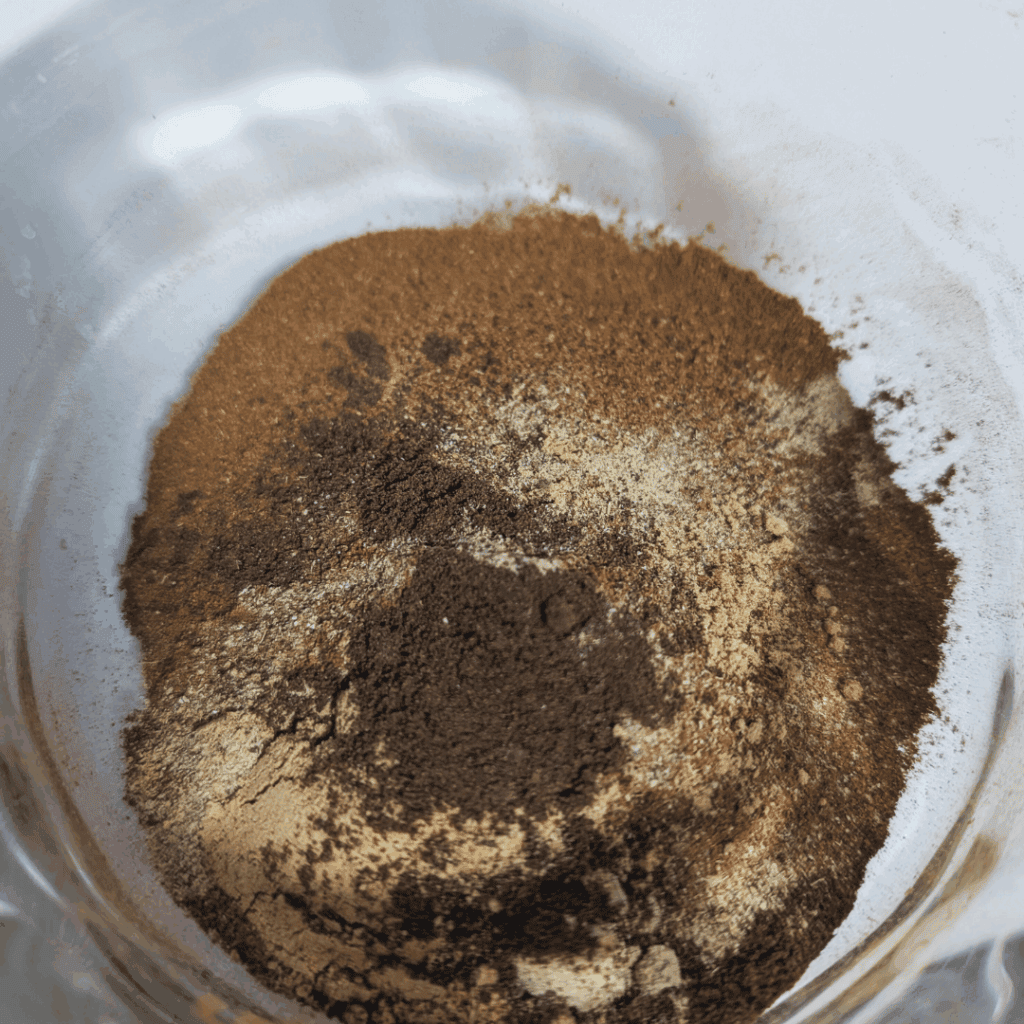 Ground spices in a glass jar for cooking.