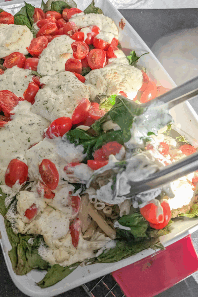 Loaded vegetable salad with creamy dressing and fresh cherry tomatoes.