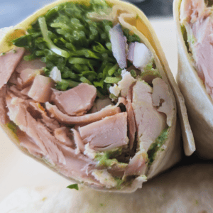 Healthy chicken wrap with fresh greens and vegetables for a quick lunch.