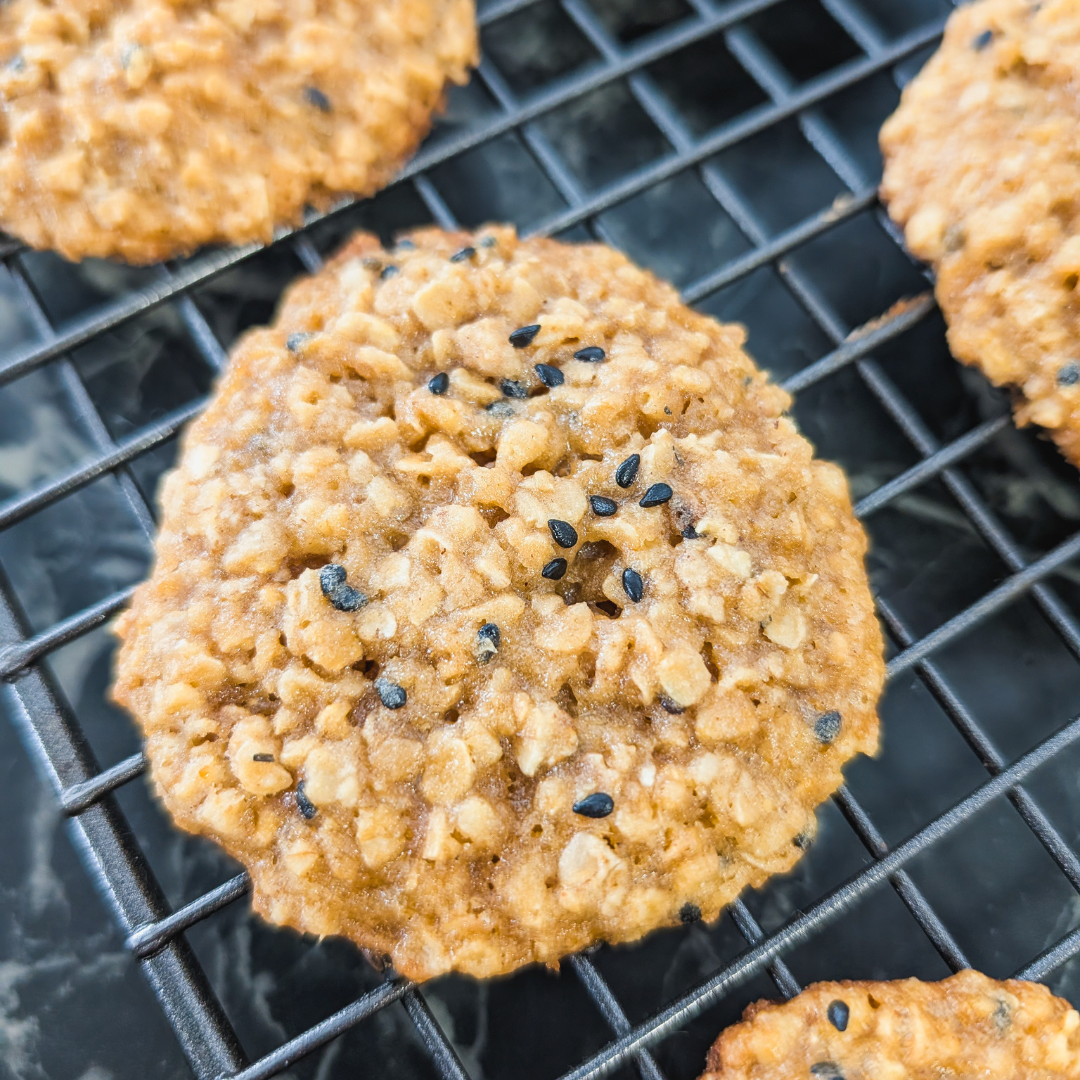 Delicious chewy oatmeal cookies topped with black sesame seeds, perfect for a cozy treat or dessert.