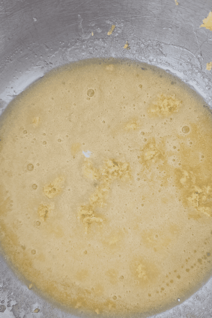 Blueberry muffin batter with frozen Canadian wild blueberries in mixing bowl.