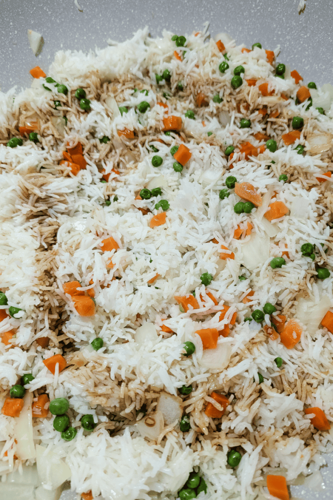 Delicious shrimp fried rice with eggs, carrots, and peas, perfect for quick weeknight dinners.