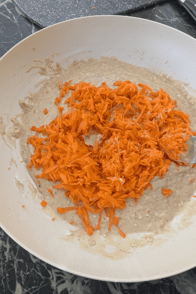 Grated carrots in a bowl for carrot oatmeal muffins recipe.