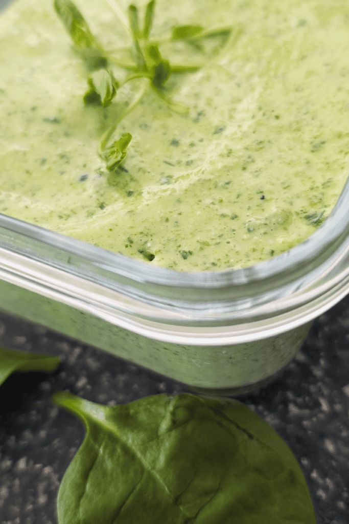 Fresh spinach and cottage cheese dip in a glass container, ready to serve.