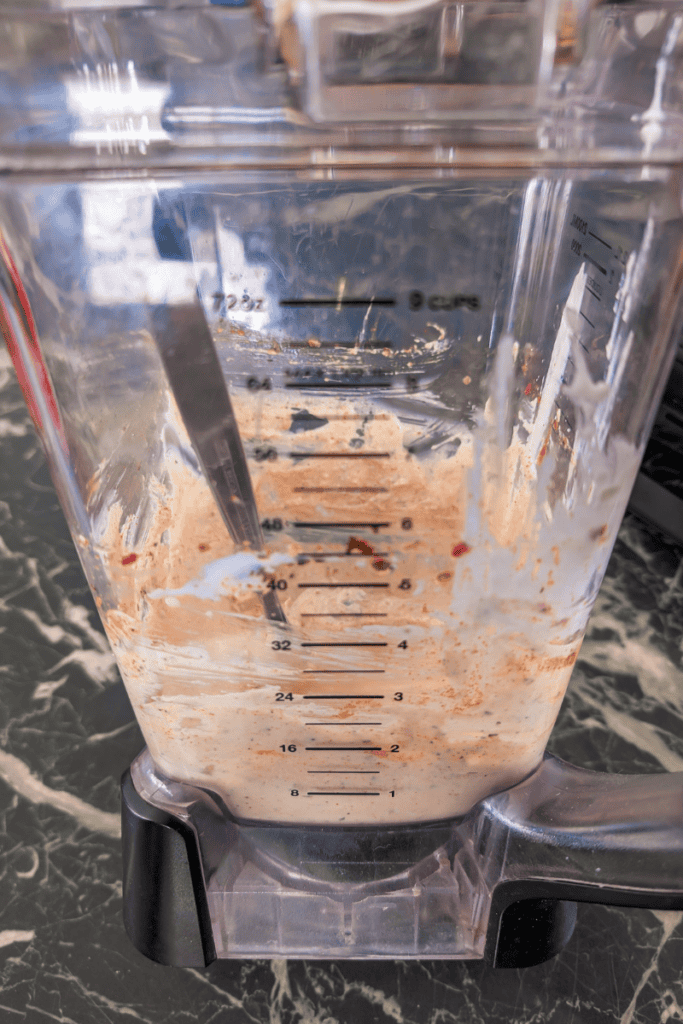 Blender with cottage cheese and herbs for salad dressing.