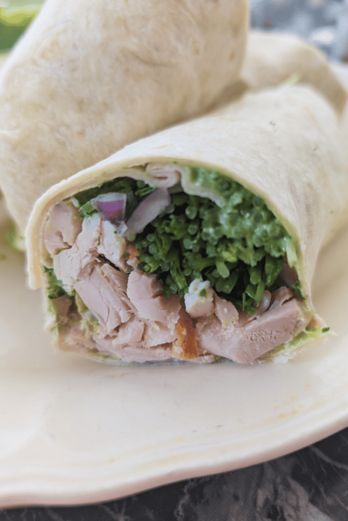 Healthy chicken wrap with fresh greens and leftover chicken. Perfect for quick, nutritious lunches.