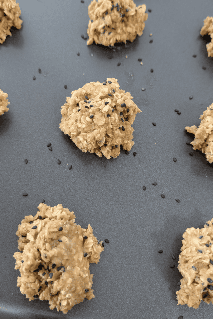 Delicious chewy oatmeal cookies topped with black sesame seeds, perfect for a cozy treat or snack.