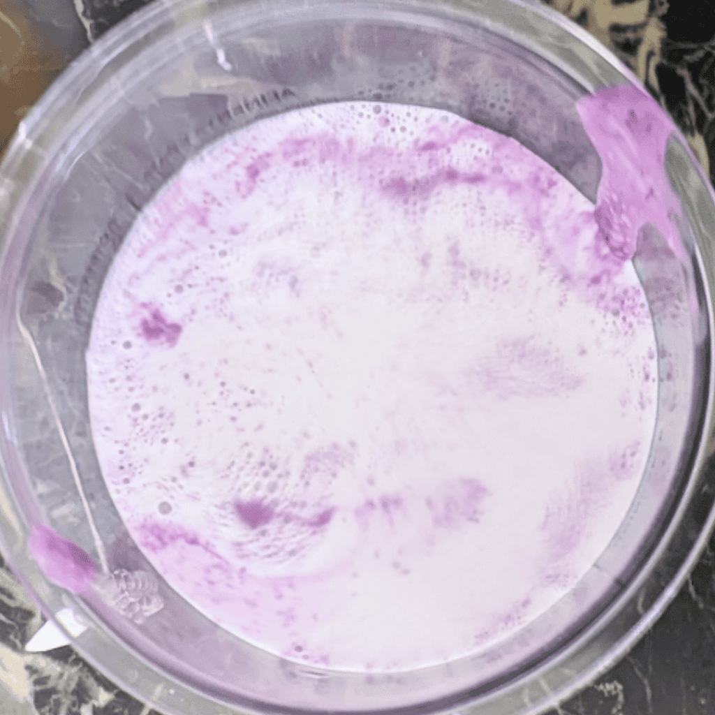 Delicious blueberry ice cream topped with rich blueberry reduction, perfect for summer desserts.