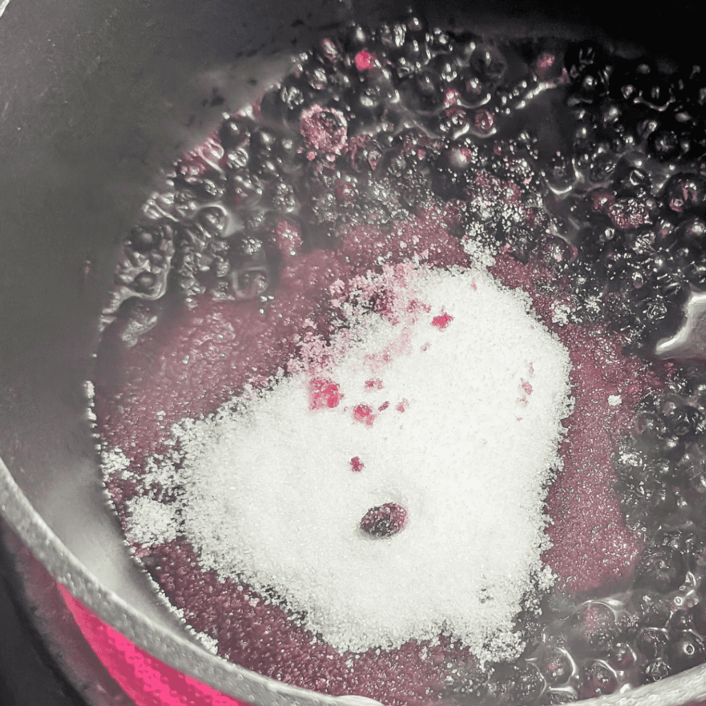 Blueberry ice cream mixture with reduction in a pan, ready to freeze.