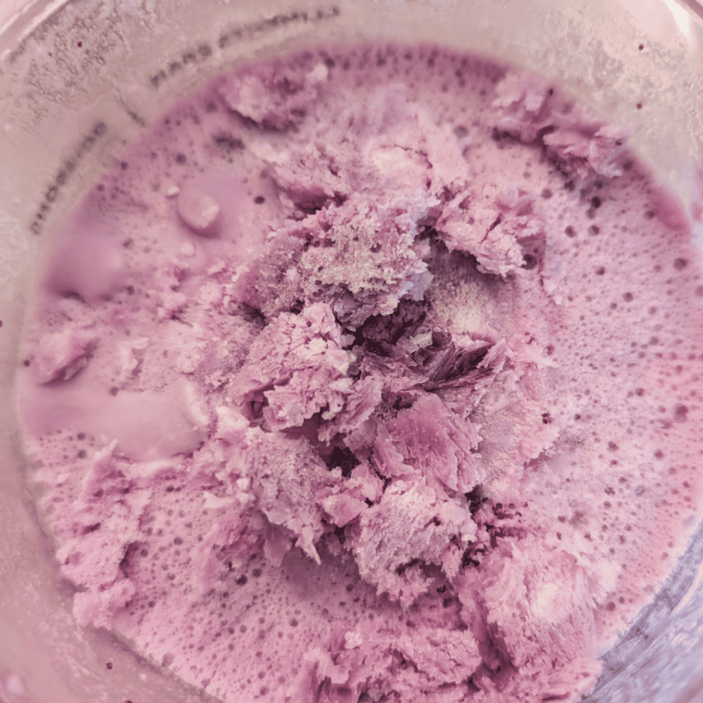 Delicious homemade blueberry ice cream with a rich blueberry reduction swirl. Perfect for summer tre.