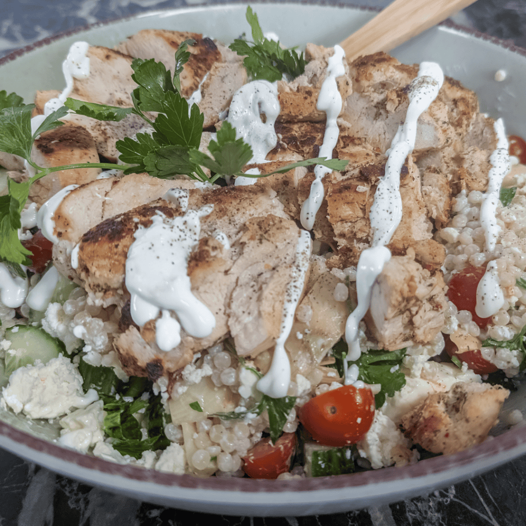 Healthy chicken couscous salad with fresh vegetables and creamy Greek yogurt dressing.