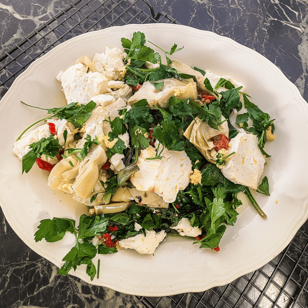 Delicious spinach artichoke bake featuring feta cheese and sun-dried tomatoes, perfect for a flavorf.