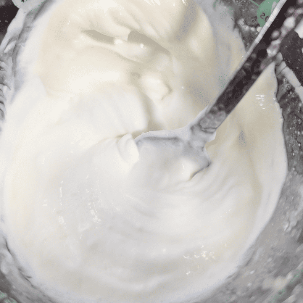 Smooth Greek yogurt dressing in a bowl, perfect for chicken couscous salad.