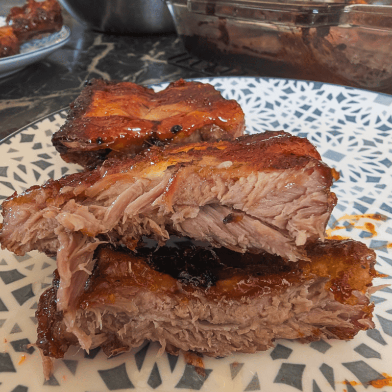 Juicy, glazed oven-cooked ribs with crispy edges, perfect for a flavorful meal.