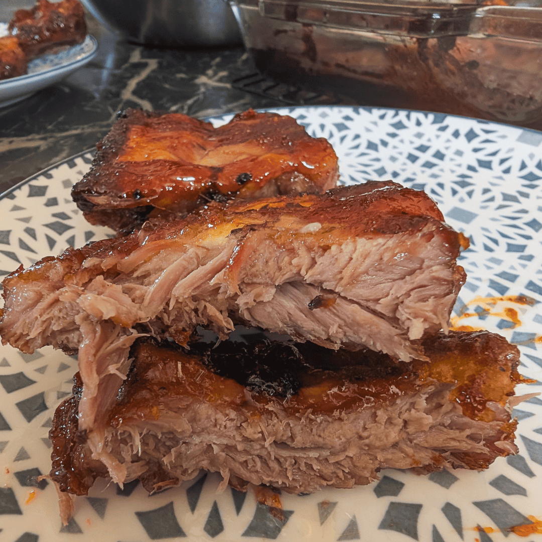 Juicy, glazed oven-cooked ribs with crispy edges, perfect for a flavorful meal.