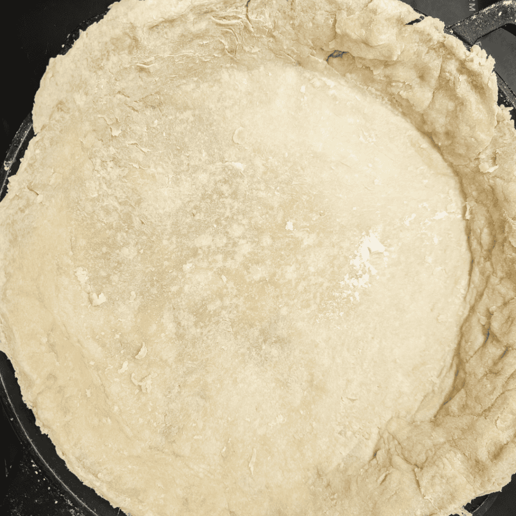 Pie crust ready for ham and asparagus quiche recipe.