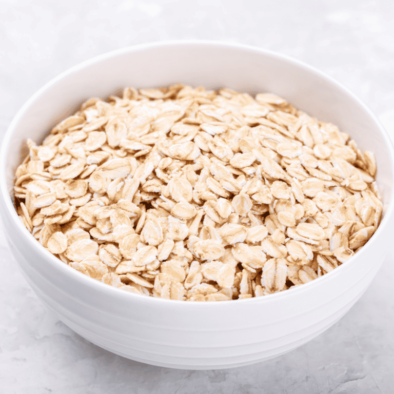 Old-fashioned oats in a white bowl for healthy breakfast.