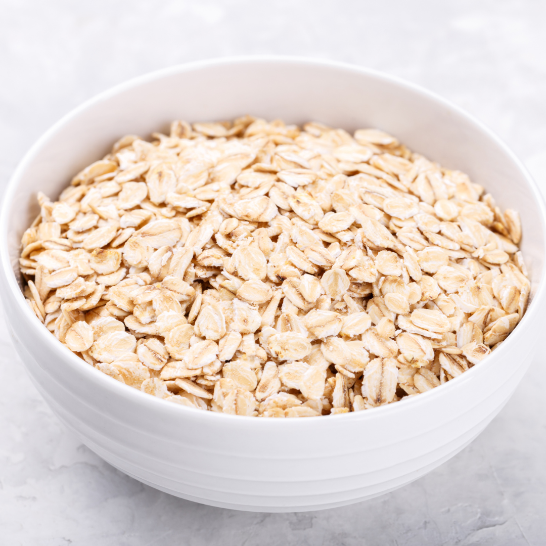 Old-fashioned oats in a white bowl for healthy breakfast.
