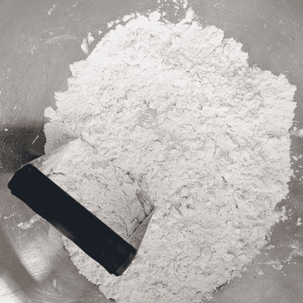Flour in a bowl for ham and asparagus quiche recipe.