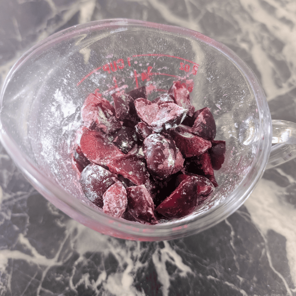Frozen cranberries in a measuring cup for cooking and baking recipes.