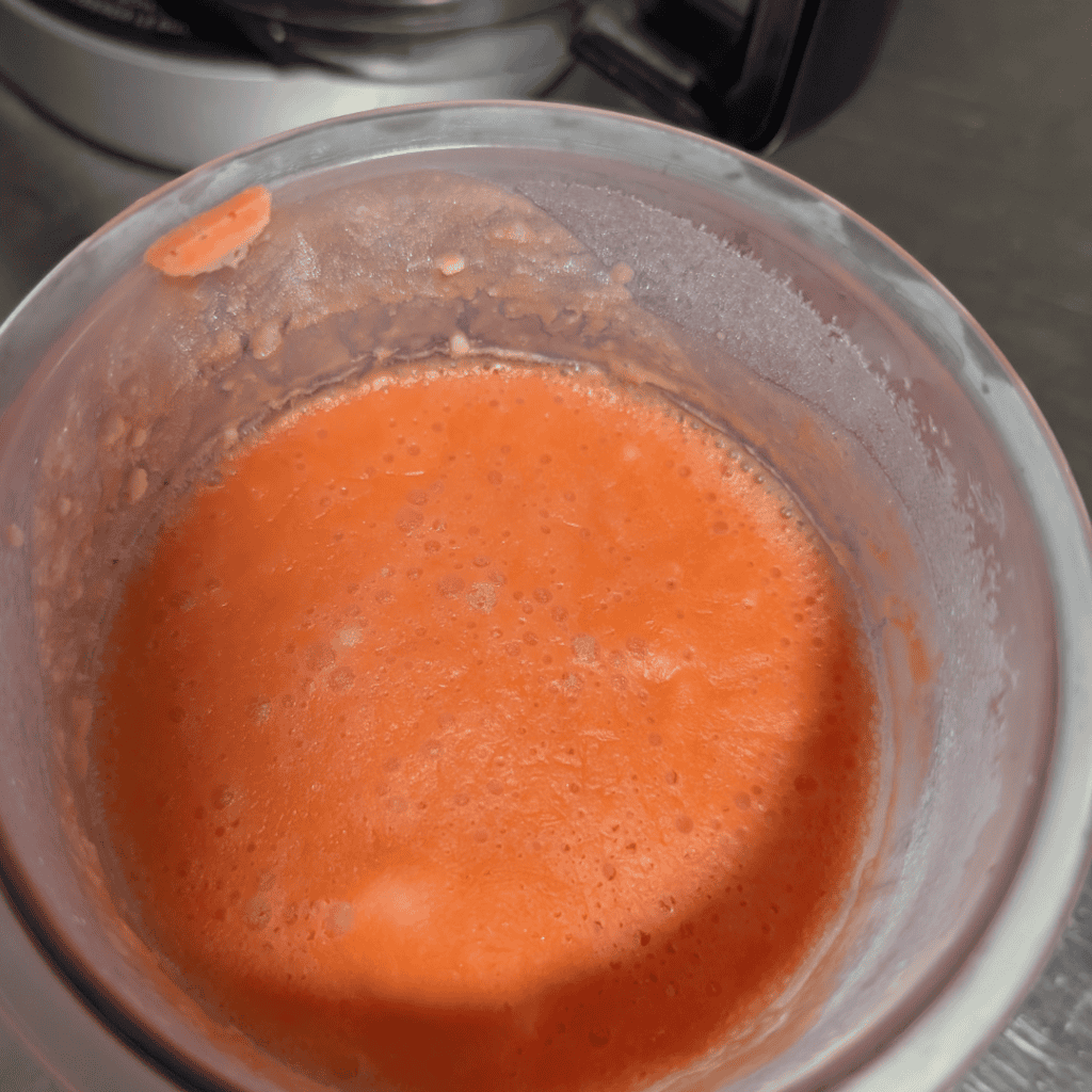 Blended orange creamsicle mixture in a blender for Ninja Creami.