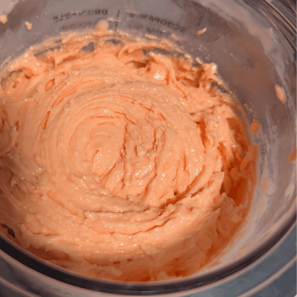 Orange Creamsicle Ninja Creami Ice Cream in a blender container.